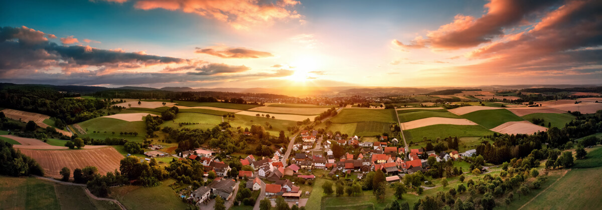 our-story-02 aerial panorama of a village at sunrise